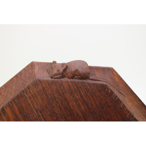 42 - Workshop of Robert 'Mouseman' Thompson, a carved oak breadboard, of octagonal form, with canted corn... 