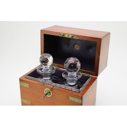 45 - A Victorian oak decanter box with brass banding, containing two cut glass decanter bottles, purple l... 