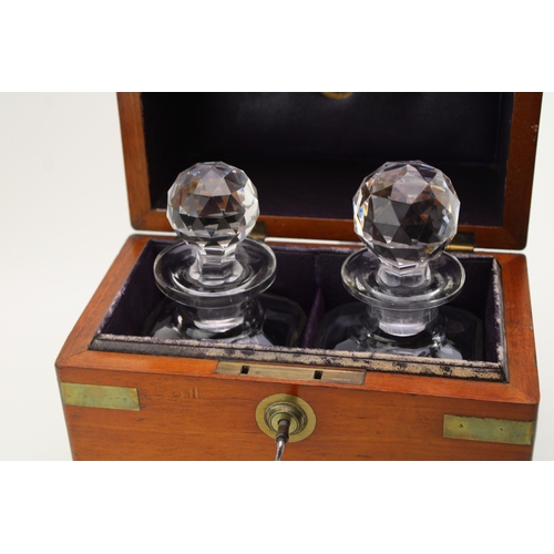 45 - A Victorian oak decanter box with brass banding, containing two cut glass decanter bottles, purple l... 
