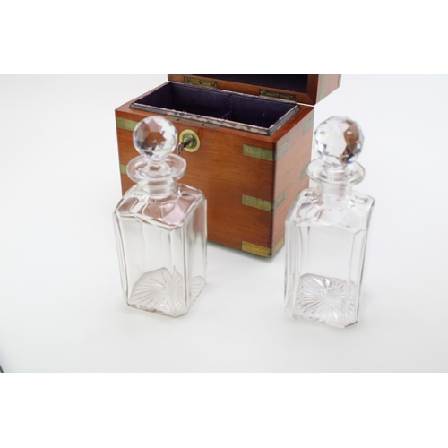 45 - A Victorian oak decanter box with brass banding, containing two cut glass decanter bottles, purple l... 