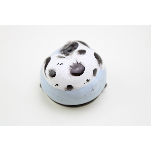 5 - A Bilston Enamel bonbonniere / patch box, modelled as a recumbent black and white King Charles Spani... 