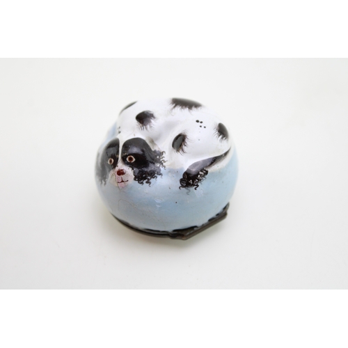 5 - A Bilston Enamel bonbonniere / patch box, modelled as a recumbent black and white King Charles Spani... 