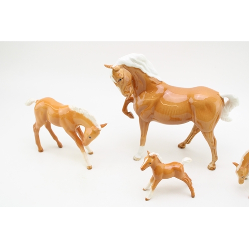 317 - Beswick palomino horses to include a leg tucked horse and three foals (4).
