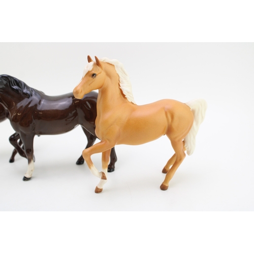 349 - Beswick horses to include a brown stocky jogging mare with a brown and matte palomino prancing arab ... 