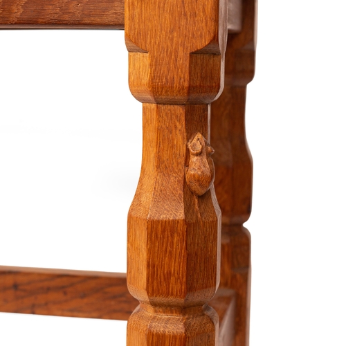 16 - Robert 'Mouseman' Thompson: an oak coffee table, the curved adzed rectangular top on four octagonal ... 
