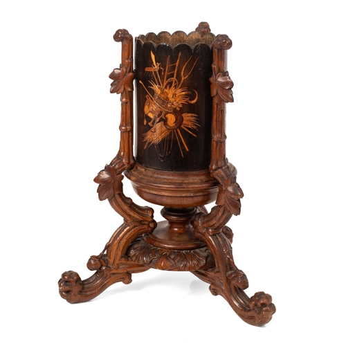 7 - A late 19th / early 20th century Black Forest wooden cylindrical vase, raised on carved tripod base ... 