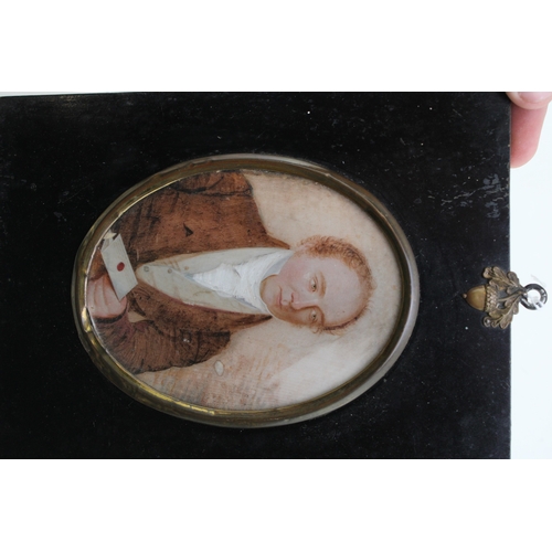 11 - A mid 19th century portrait miniature of a gentleman holding a letter, of oval form delicately paint... 