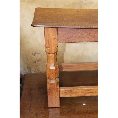 16 - Robert 'Mouseman' Thompson: an oak coffee table, the curved adzed rectangular top on four octagonal ... 