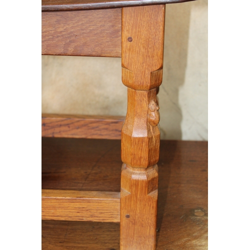 16 - Robert 'Mouseman' Thompson: an oak coffee table, the curved adzed rectangular top on four octagonal ... 