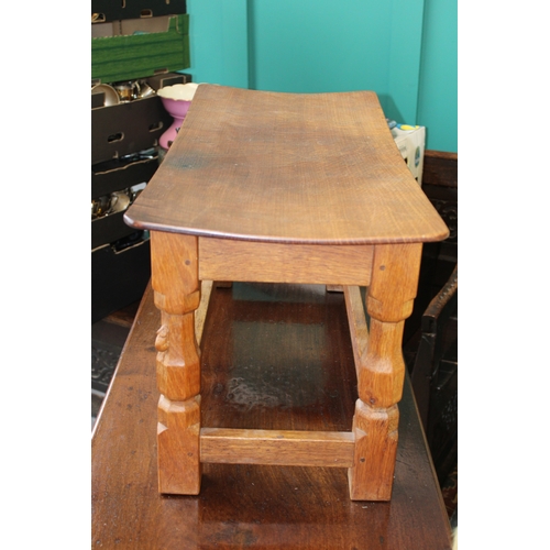 16 - Robert 'Mouseman' Thompson: an oak coffee table, the curved adzed rectangular top on four octagonal ... 