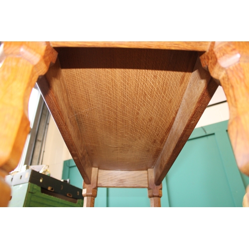 16 - Robert 'Mouseman' Thompson: an oak coffee table, the curved adzed rectangular top on four octagonal ... 