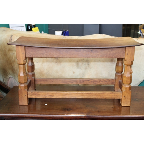 16 - Robert 'Mouseman' Thompson: an oak coffee table, the curved adzed rectangular top on four octagonal ... 