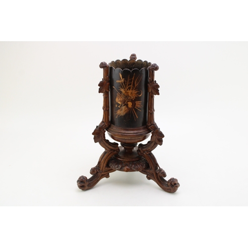 7 - A late 19th / early 20th century Black Forest wooden cylindrical vase, raised on carved tripod base ... 