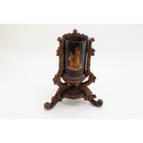 7 - A late 19th / early 20th century Black Forest wooden cylindrical vase, raised on carved tripod base ... 