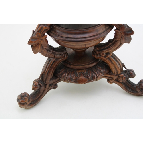 7 - A late 19th / early 20th century Black Forest wooden cylindrical vase, raised on carved tripod base ... 