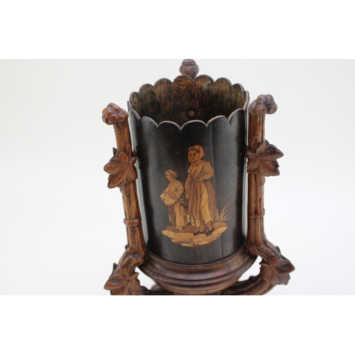 7 - A late 19th / early 20th century Black Forest wooden cylindrical vase, raised on carved tripod base ... 