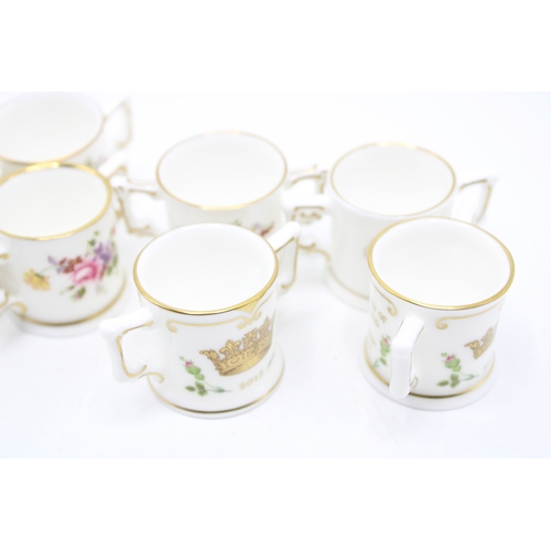 54 - A collection of Royal Crown Derby miniature loving cups to include Prince George, Princess Charlotte... 