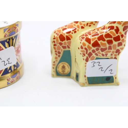 59 - Two boxed Royal Crown Derby paperweights to include a pair of giraffes and a toy drum with drumstick... 