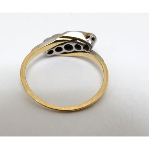 1003 - An 18ct gold ring set with 5 platinum set graduated diamonds