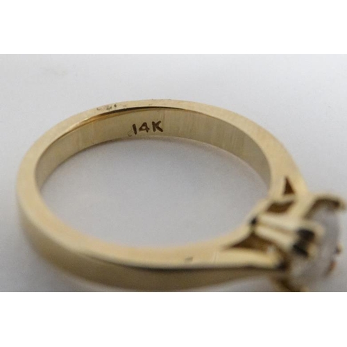 1004 - A 14k gold ring set with diamond solitaire