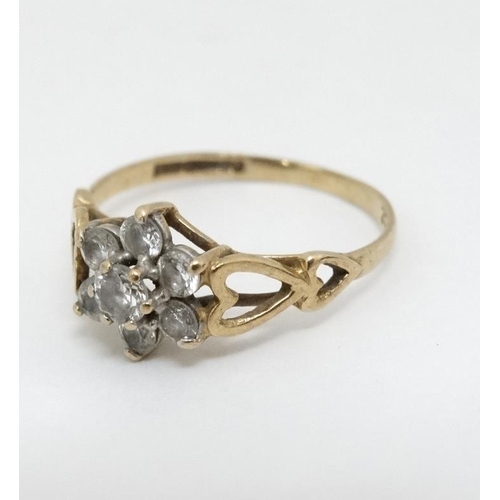 1010 - A 9ct gold ring set with 7 white stones