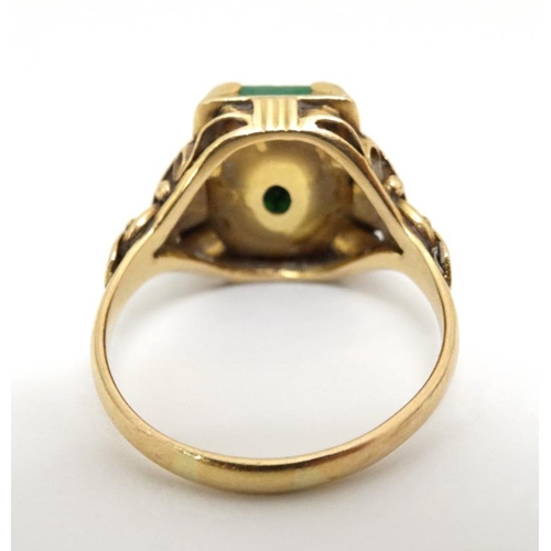 1013 - A Chinese 22ct gold ring set with jade like hardstone stone to top