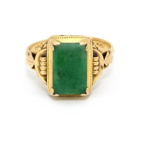 1013 - A Chinese 22ct gold ring set with jade like hardstone stone to top