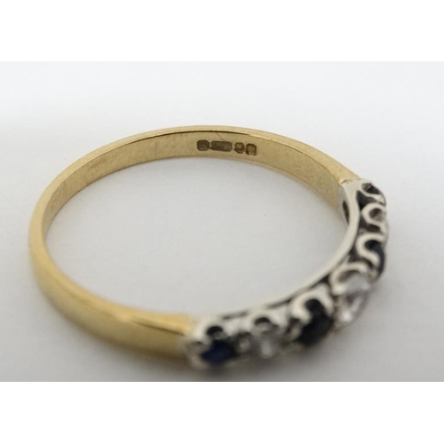 1023 - A 9ct gold ring set with diamonds, blue and white stones