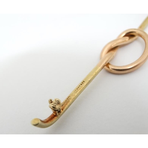 1027 - A 14kt gold bar brooch with rose gold knot decoration to centre. Marked Tiffany & Co.  3'' wide