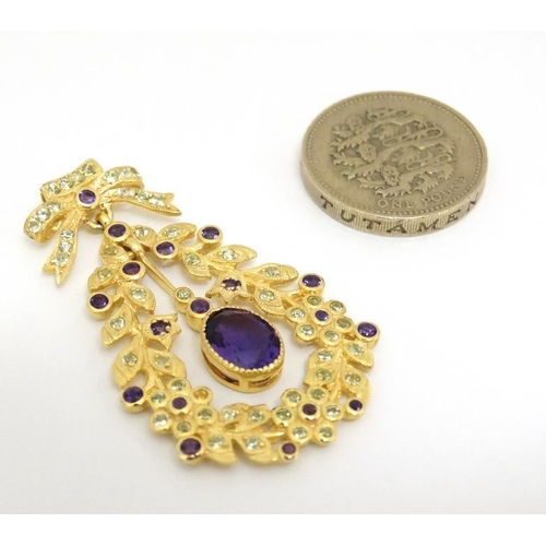 1030 - A silver gilt pendant set with amethyst and peridot. 1 ¾'' long