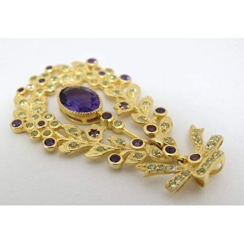 1030 - A silver gilt pendant set with amethyst and peridot. 1 ¾'' long