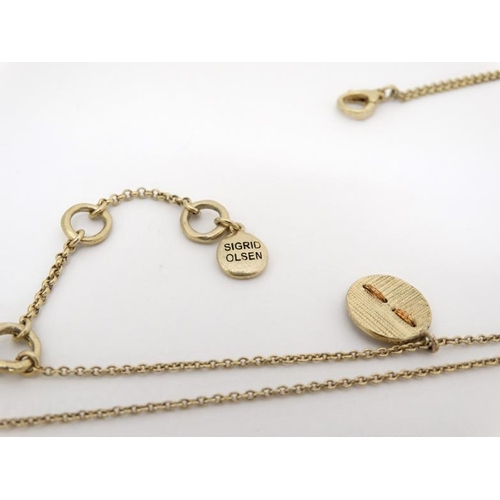 1034 - Sigrid Oslen : A gilt metal necklace and pendant by Sigrid Olsen. The pendant approx. 1 ¼'' diameter