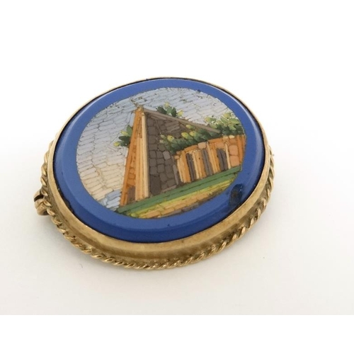 1035 - Micro Mosaic : A 9ct gold brooch set with oval micro mosaic scene to centre . Approx 1'' wide.