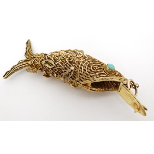 1041 - A silver gilt pendant / vinaigrette formed as an articulated fish set with turquoise cabochon. 2 ¾''... 