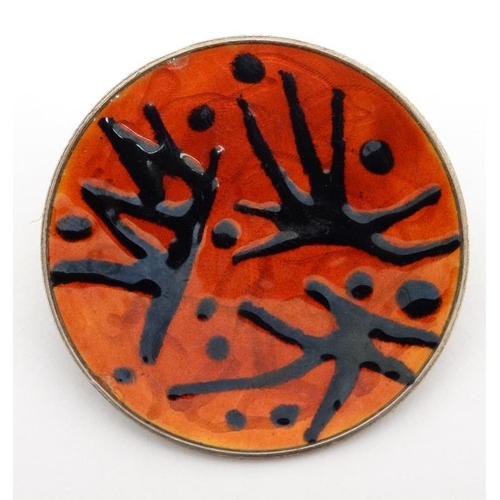 1046 - Scandinavian Jewellery : A silver brooch with red guilloche enamel and black enamel abstract decorat... 