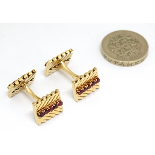 1054 - Van Cleef & Arpels : A pair of 18ct gold cufflinks with chevron design set with rows of rubies. Numb... 