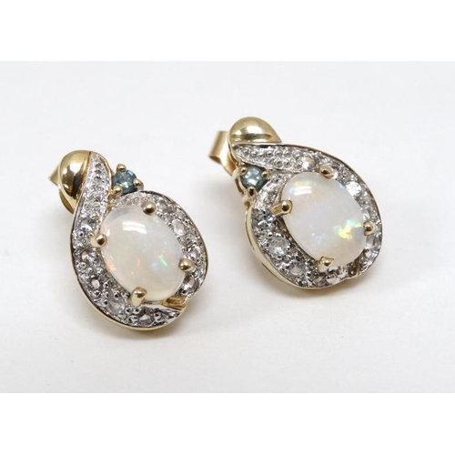 1057 - A pair of 9ct gold earrings set with opals, white stones and green stone. Approx. ½'' long