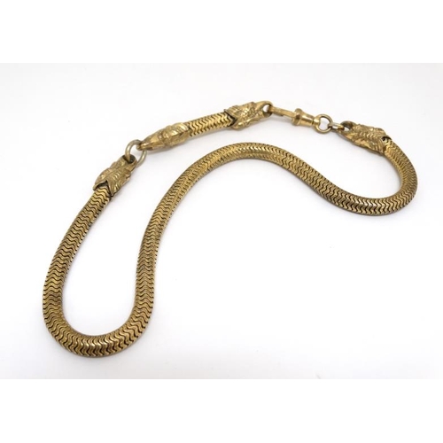 1060 - A gilt metal watch chain / choker with serpent/dolphin decoration. Approx 15'' long