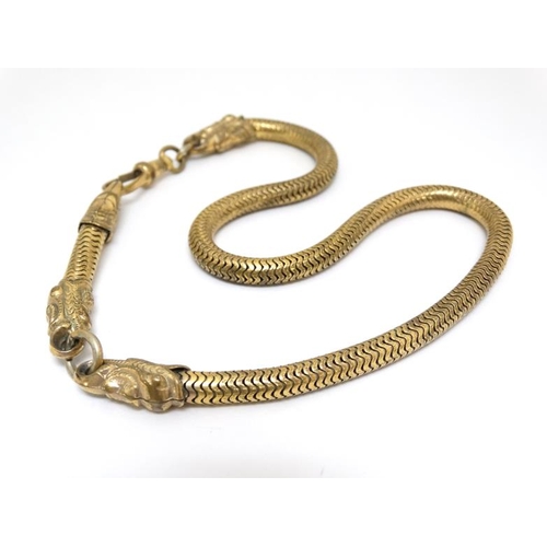 1060 - A gilt metal watch chain / choker with serpent/dolphin decoration. Approx 15'' long