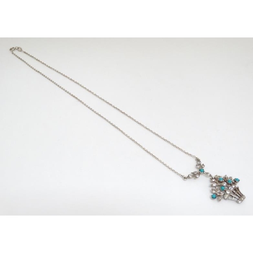 1062 - A silver necklace with pendant of flowering basket form set with white stones and turquoise cabochon... 