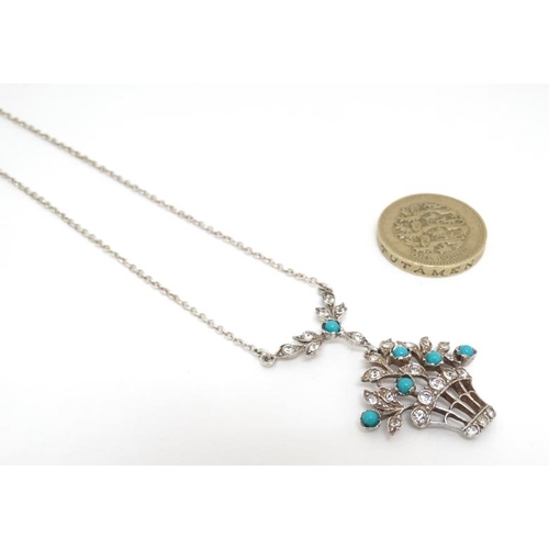 1062 - A silver necklace with pendant of flowering basket form set with white stones and turquoise cabochon... 