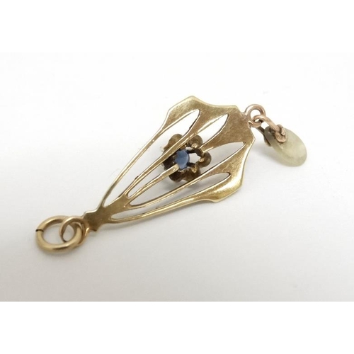 1063 - A gilt metal pendant set with central blue stone and mother of pearl drop . approx. 1'' long