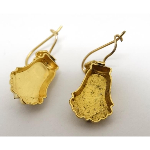 1071 - A pair of gilt metal drop earrings set with star decoration. Approx. 7/8'' long