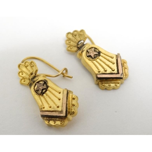 1071 - A pair of gilt metal drop earrings set with star decoration. Approx. 7/8'' long