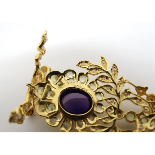 1079 - A silver gilt pendant set with central amethyst and profusion of seed pearls and peridot. Marked 'St... 