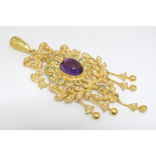 1079 - A silver gilt pendant set with central amethyst and profusion of seed pearls and peridot. Marked 'St... 