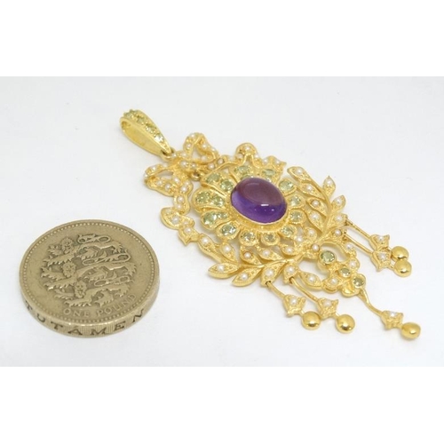 1079 - A silver gilt pendant set with central amethyst and profusion of seed pearls and peridot. Marked 'St... 