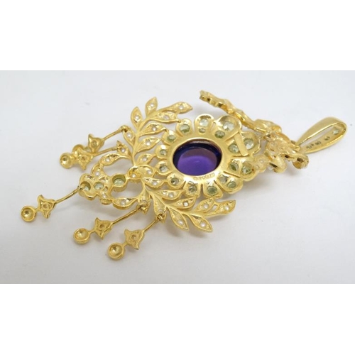 1079 - A silver gilt pendant set with central amethyst and profusion of seed pearls and peridot. Marked 'St... 