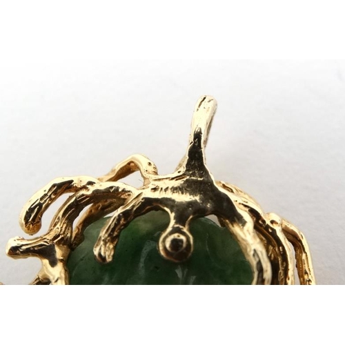 1080 - A jade pendant with 14ct gold mount. Approx 2'' long