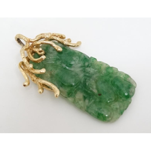 1080 - A jade pendant with 14ct gold mount. Approx 2'' long